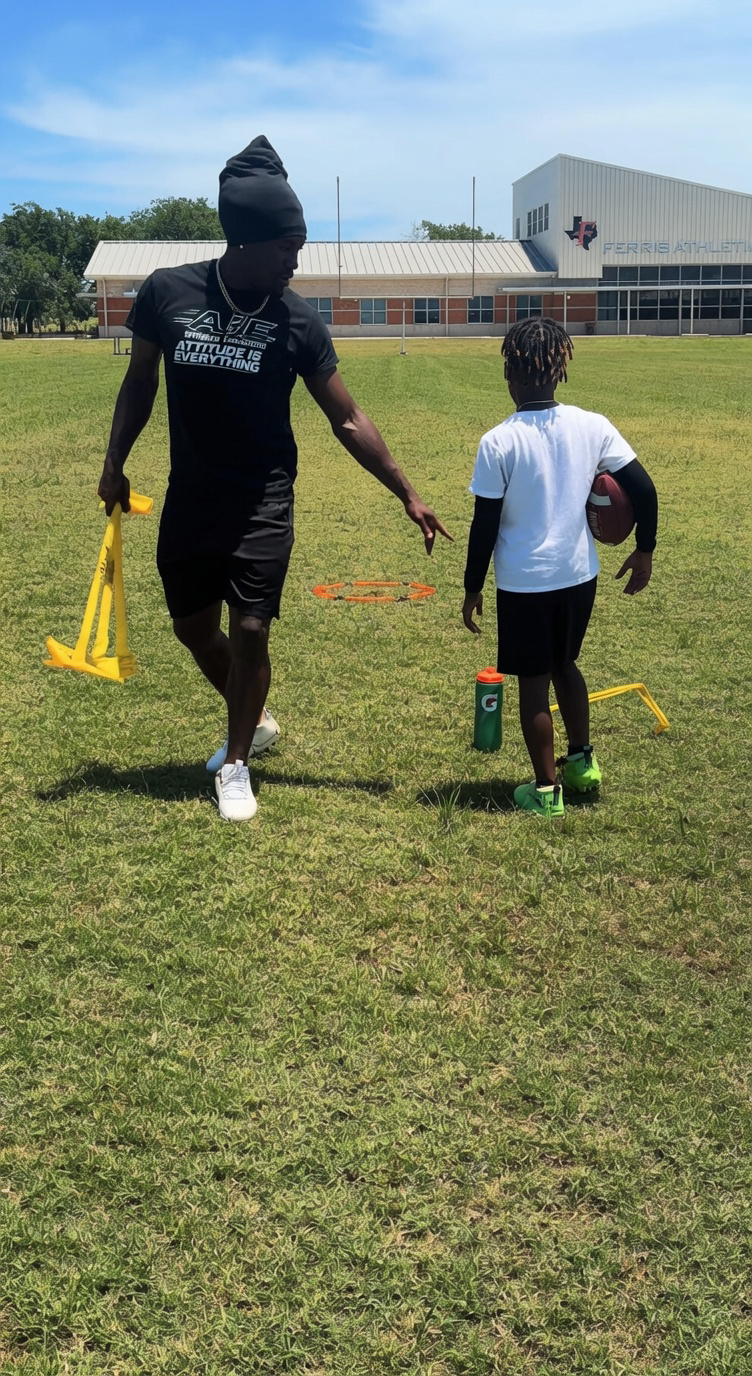 Coach G coaching a young athlete on the field